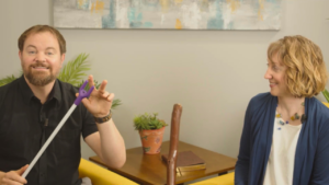 Stephen Vesolich holding a cattle prod illustration while teaching Psalm 120.