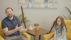 Stephen Vesolich and his daughter Ella sitting together during the Psalm 125 teaching session for The Mountains Surround Song of Ascent Series
