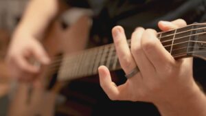 Close up photo of Stephen Vesolich playing guitar for Psalm 124