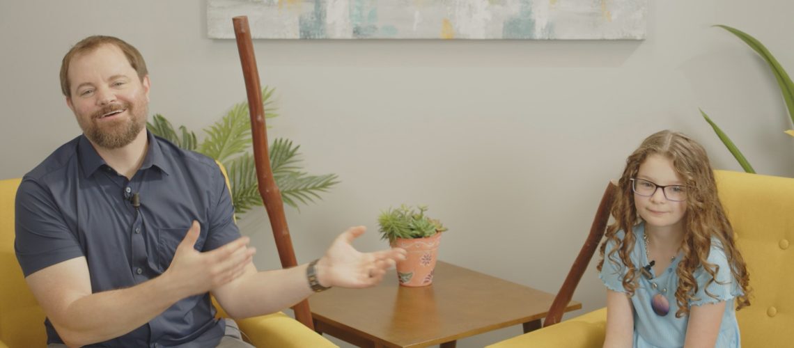 Stephen Vesolich and his daughter Ella sitting together during the Psalm 125 teaching session for The Mountains Surround Song of Ascent Series